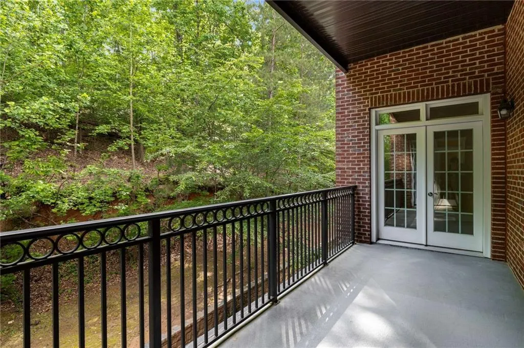 This westerly view from the covered balcony shows the glass French doors which open to the sitting room in the Primary Suite.