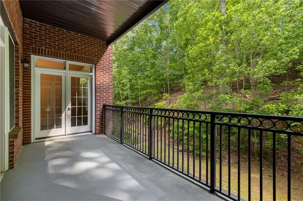 All of the views from the private Balcony primarily reveal the woods of Vinings Mountain.  The glass French doors open to the Dining Room.