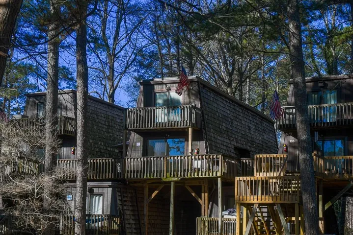 Back of house featuring a deck and a balcony