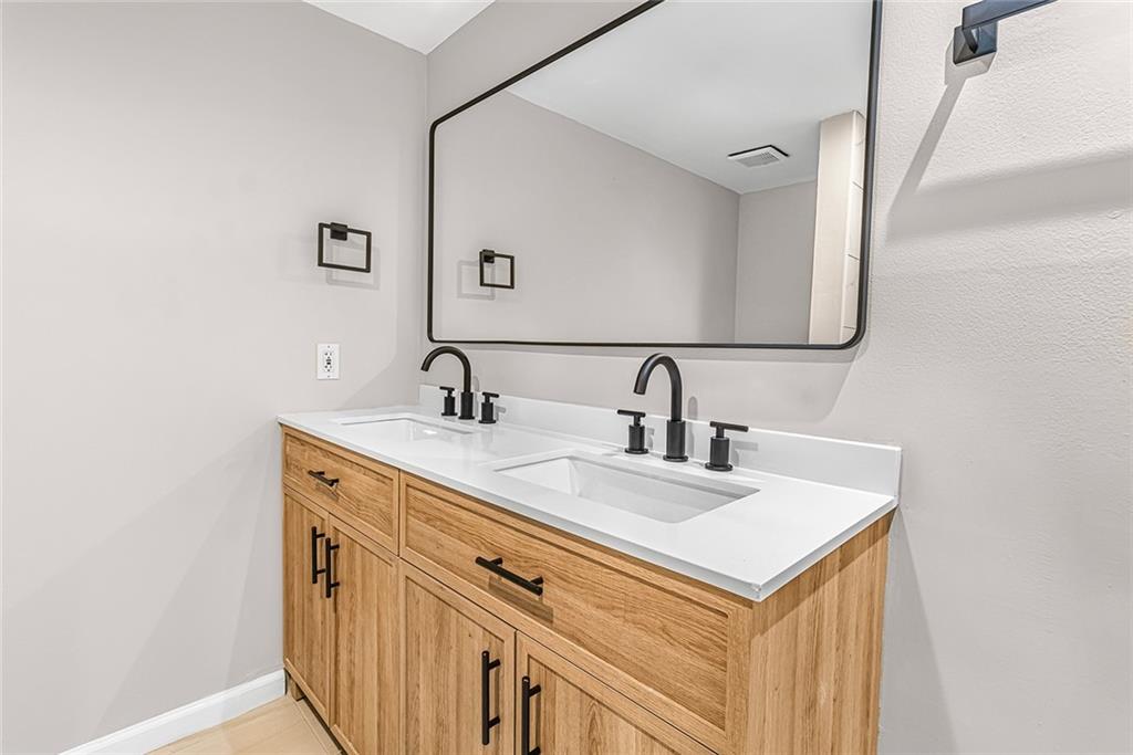 Bathroom featuring dual bowl vanity Bathroom featuring dual bowl vanity