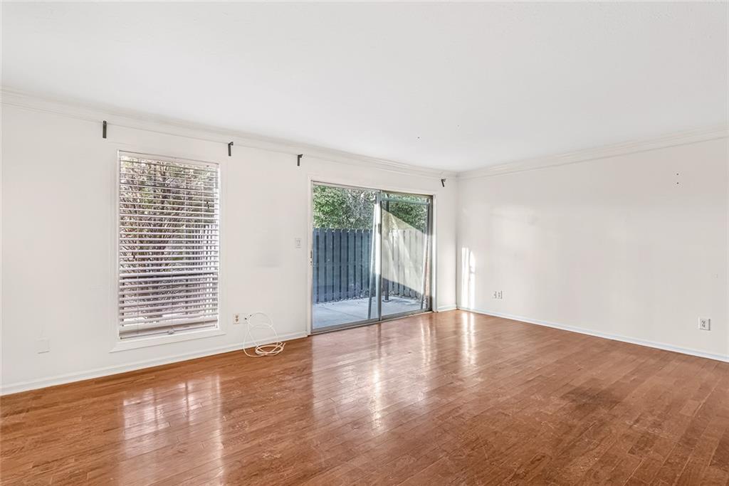 Spare room featuring ornamental molding and light hardwood / wood-style flooring Spare room featuring ornamental molding and light hardwood / wood-style flooring