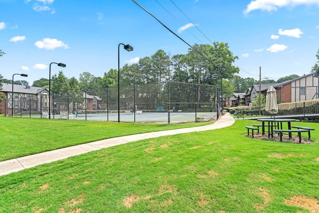 Surrounding community with a yard and tennis court Surrounding community with a yard and tennis court