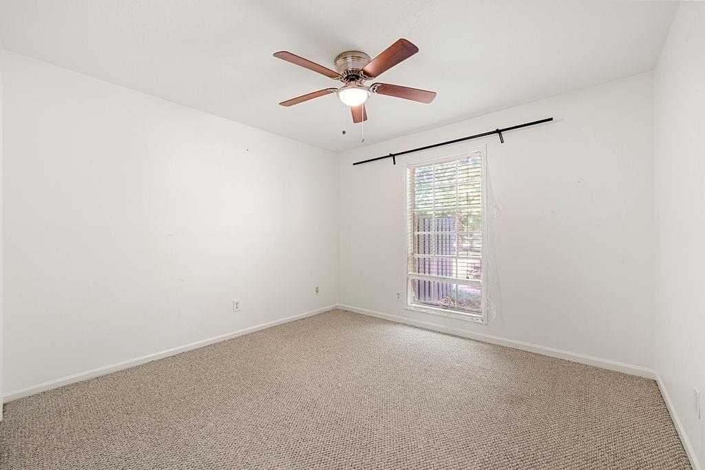 Unfurnished room featuring light colored carpet and ceiling fan Unfurnished room featuring light colored carpet and ceiling fan