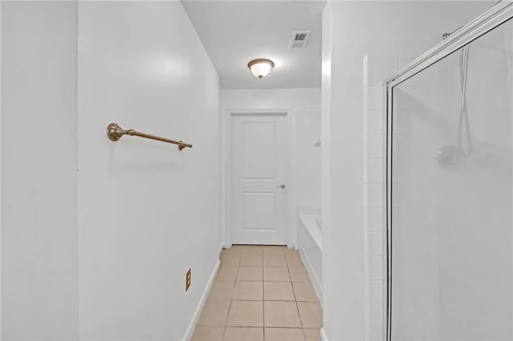 Bathroom with tile patterned floors and independent shower and bath