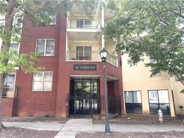 Brick exterior with balconies and a prominent entrance