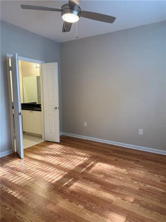 Unfurnished bedroom with light wood-type flooring and a ceiling fan