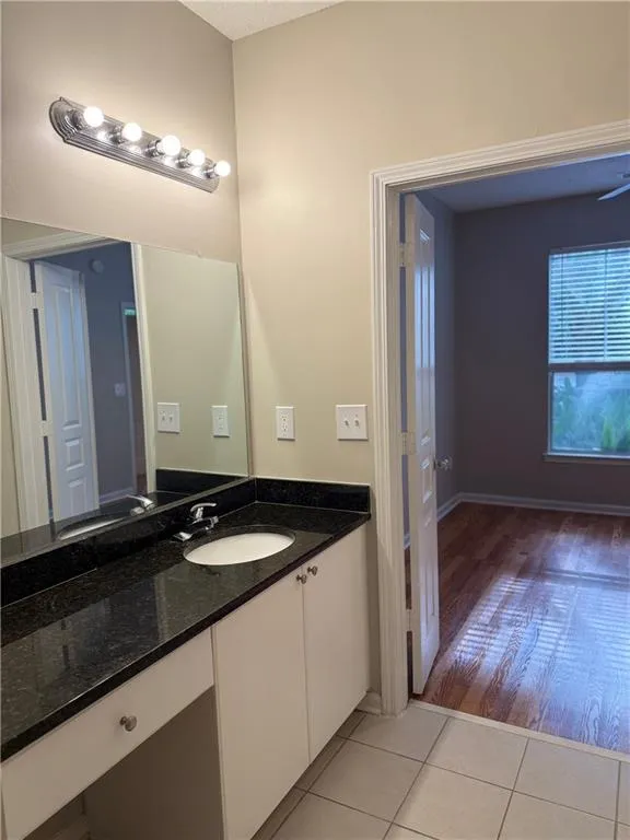 Bathroom with tile patterned floors and vanity