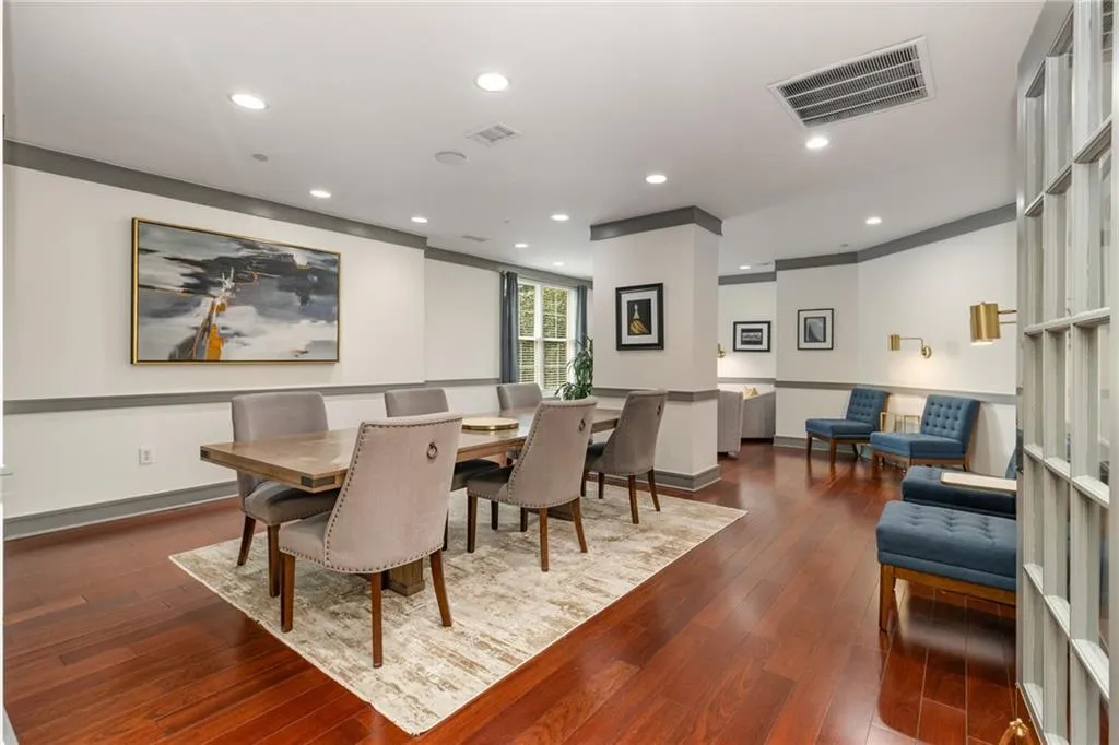 Dining space with dark wood-style floors and recessed lighting