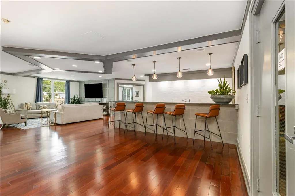 Kitchen with a kitchen bar, hanging light fixtures, a peninsula, open floor plan, and recessed lighting