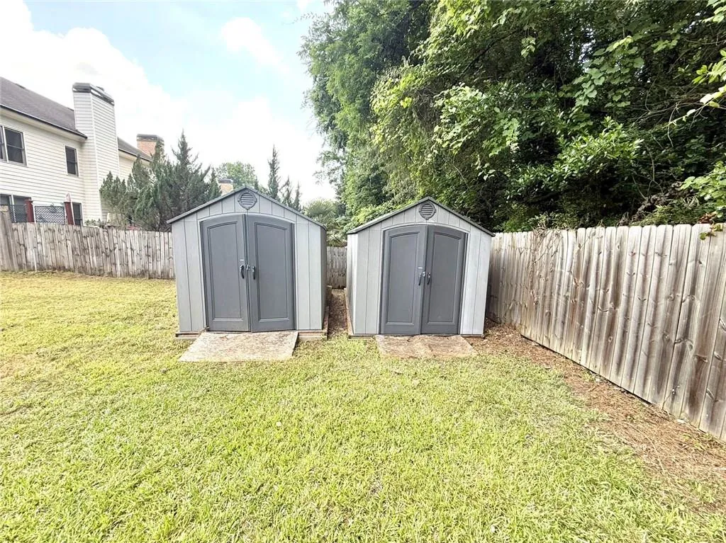 Fenced backyard with a storage shed