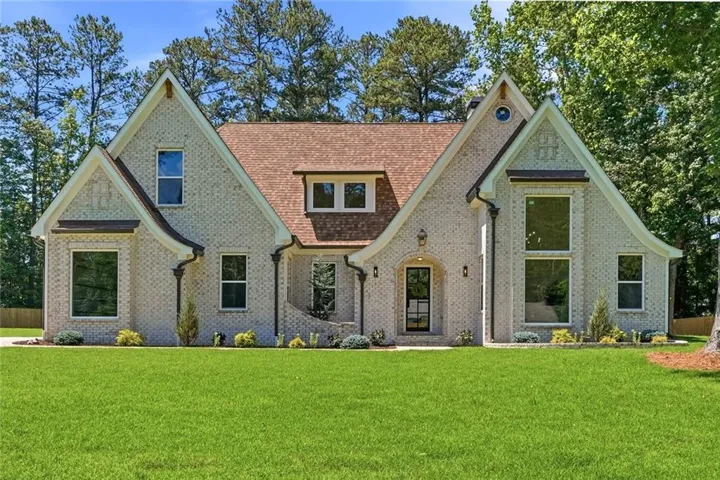 Light-colored brick exterior with multiple gables