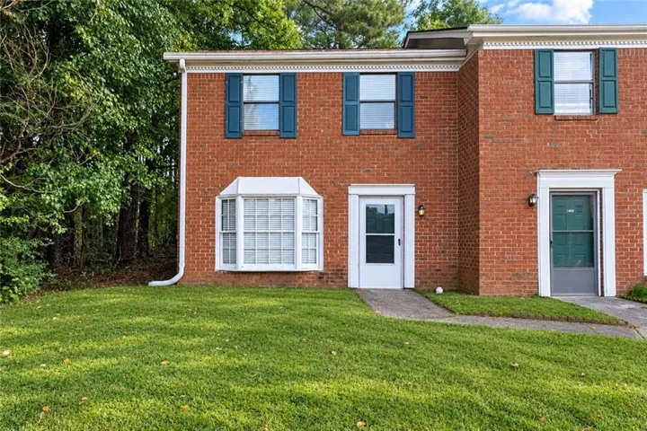 Brick exterior with decorative window shutters