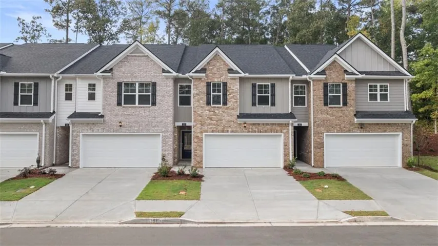 Craftsman house featuring a garage, board and batten siding, and concrete driveway