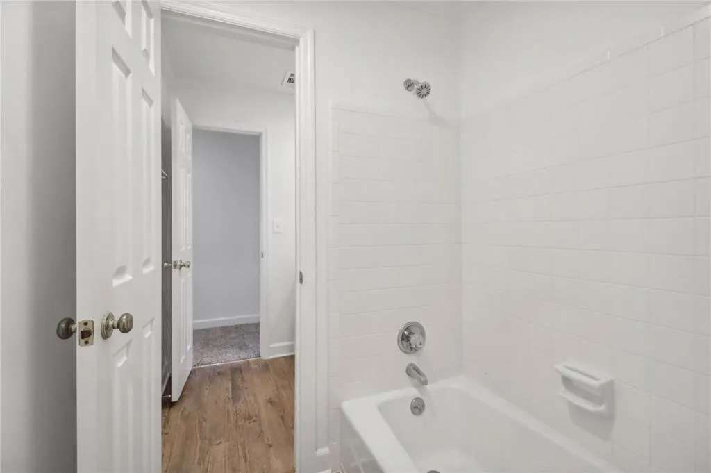 Divided by shared tub/shower combo