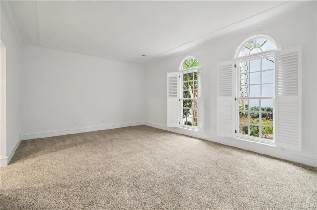 Generous Owner's retreat with plantation shutters overlooks azaleas and landscaped path