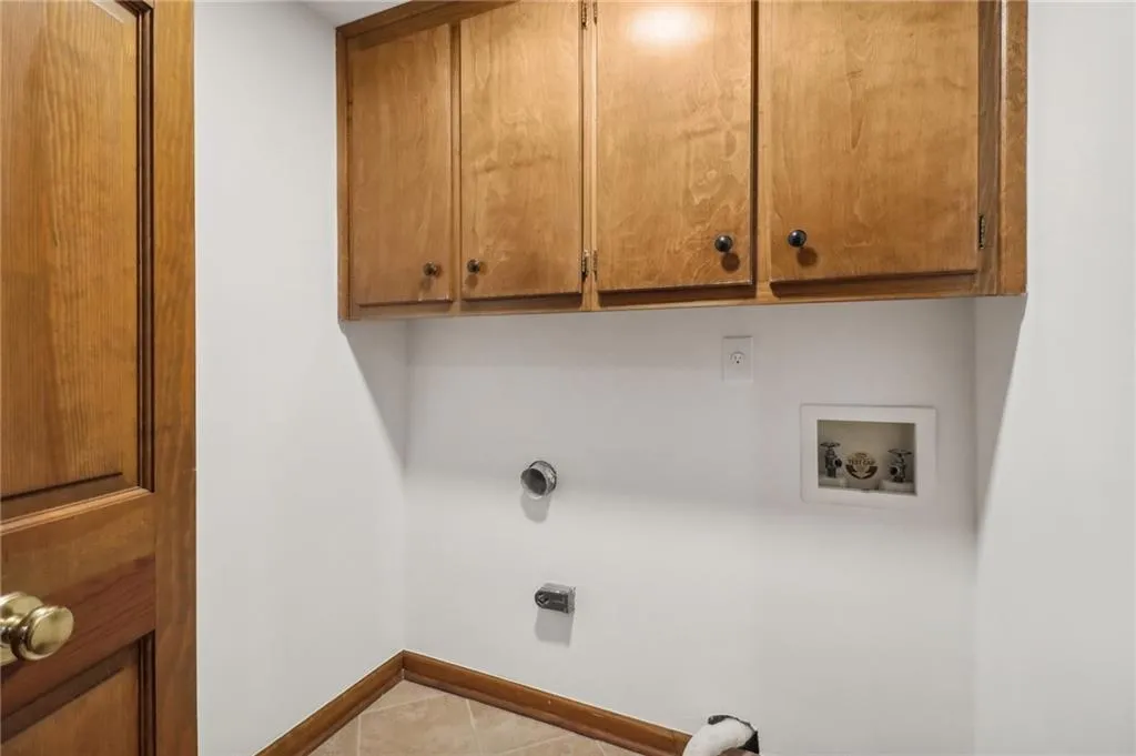 Laundry room conveniently off kitchen, closed by double doors and plenty of storage
