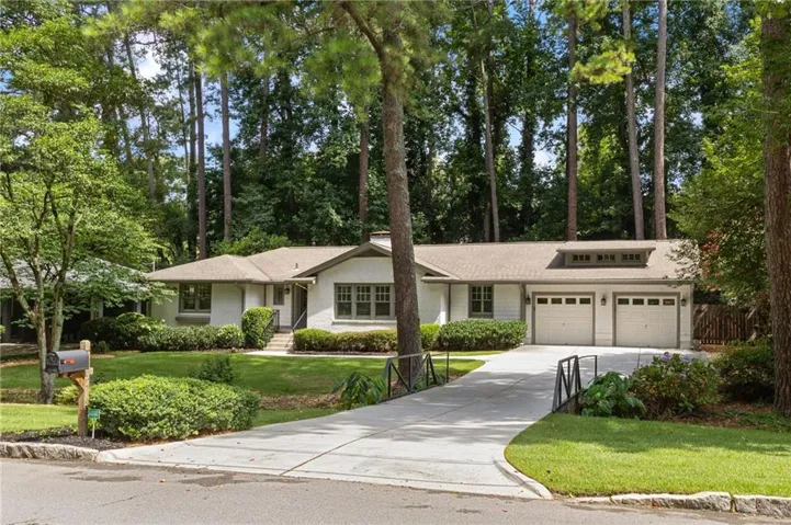 White brick exterior with a light-colored shingle roof