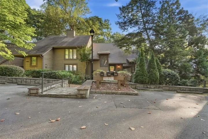 Multi-level exterior with horizontal siding and a prominent chimney