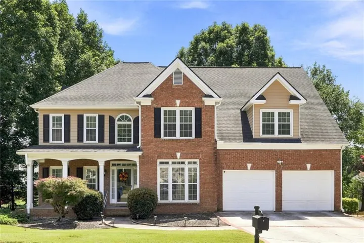 Brick facade with gabled roofline and dormer windows
