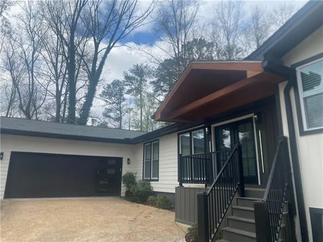 Contemporary exterior with light-colored siding and dark trim