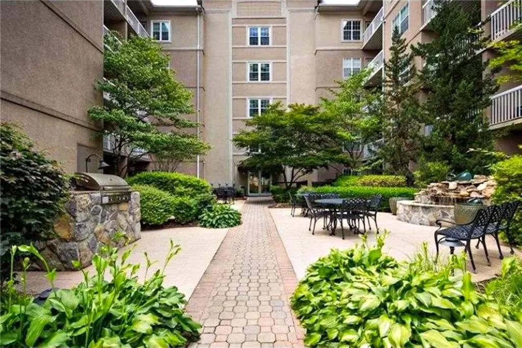 View of community with area for grilling and a patio