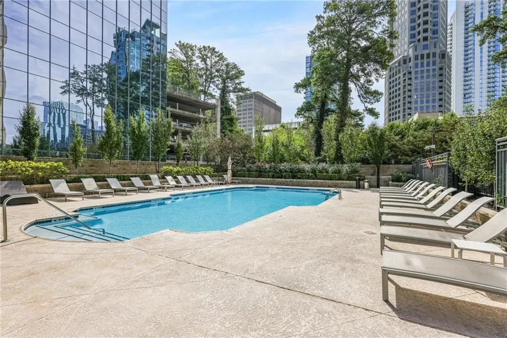 Community pool featuring a patio area and a city view