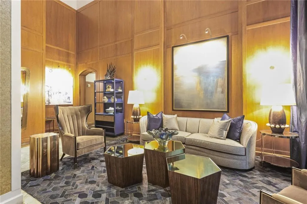 Living area featuring wooden walls and a high ceiling
