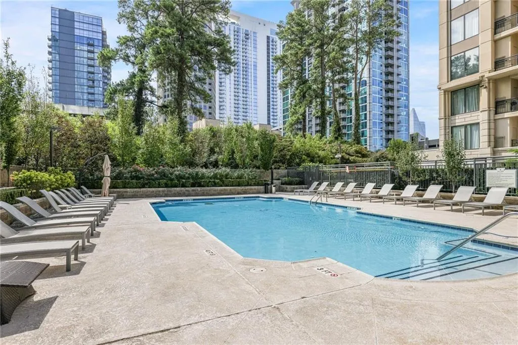 Community pool with a patio and a city view