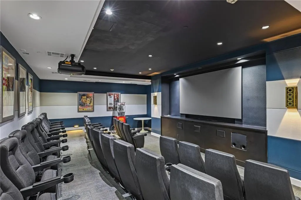 Carpeted cinema featuring recessed lighting and a tray ceiling
