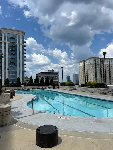 Community pool with a view of city and a patio