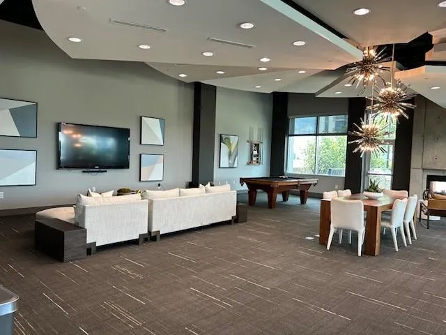 Playroom featuring carpet flooring, recessed lighting, a towering ceiling, and pool table