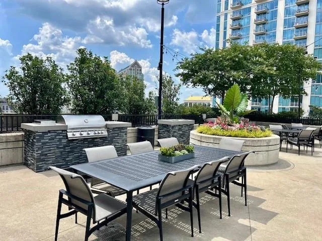 View of patio with outdoor dining area and exterior kitchen