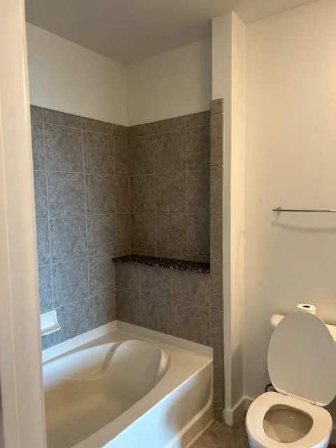 Full bathroom featuring tile patterned floors and toilet