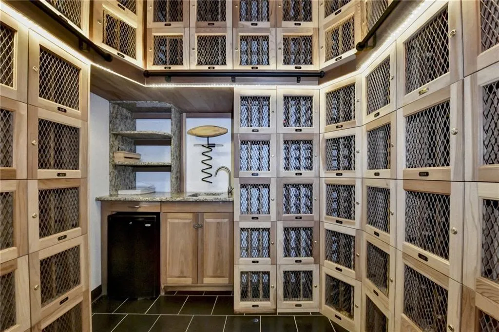 Wine cellar with dark tile patterned flooring and sink