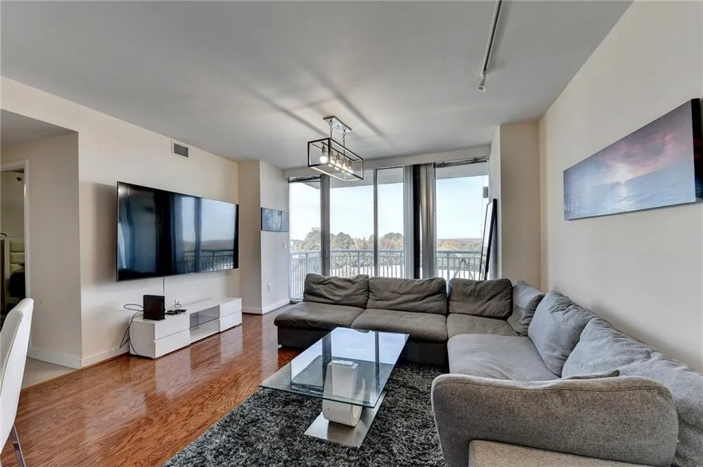 Living room featuring hardwood / wood-style flooring and rail lighting