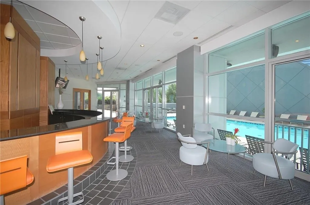 Bar with carpet flooring and hanging light fixtures