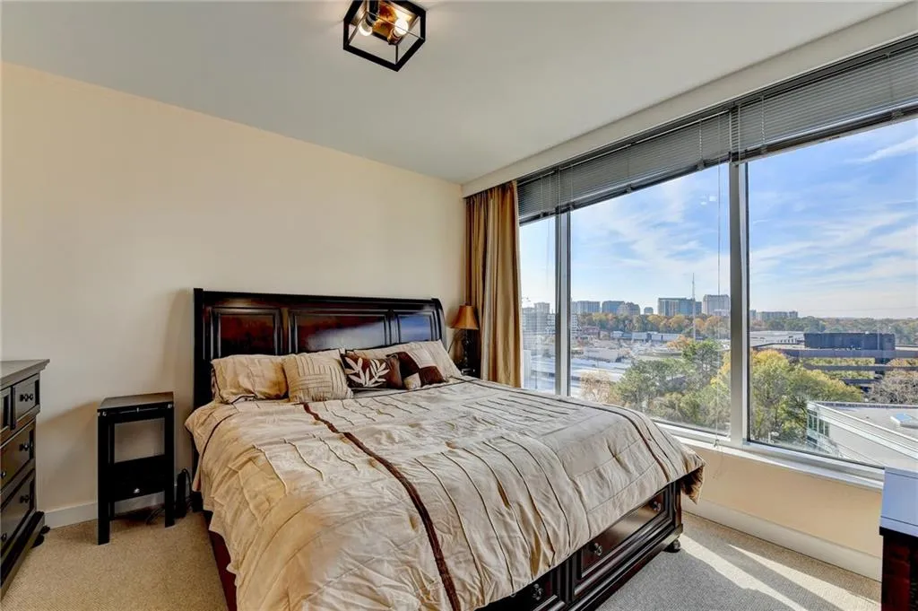 Carpeted bedroom with multiple windows