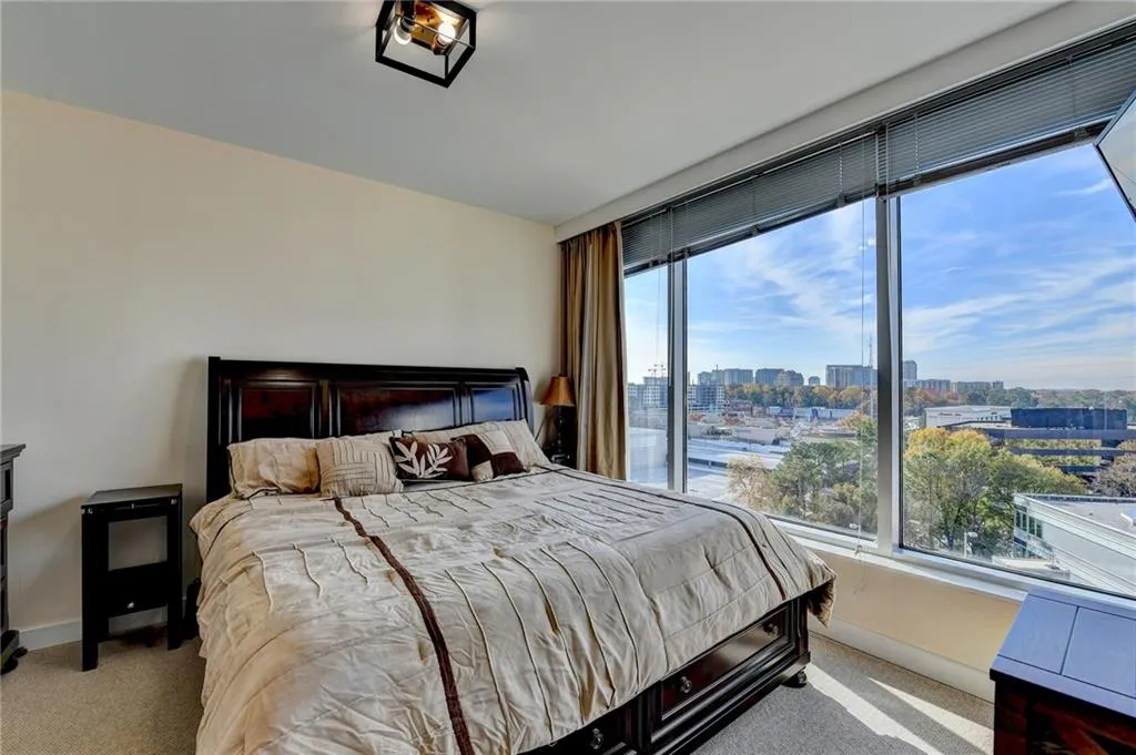 Carpeted bedroom with multiple windows