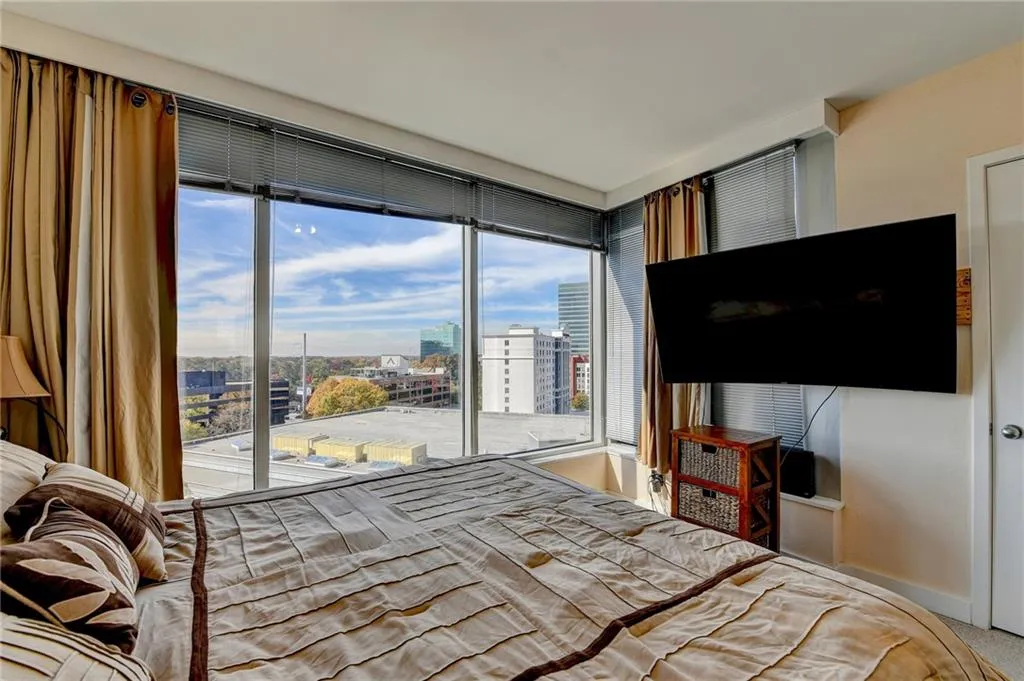 Carpeted bedroom with access to outside and multiple windows