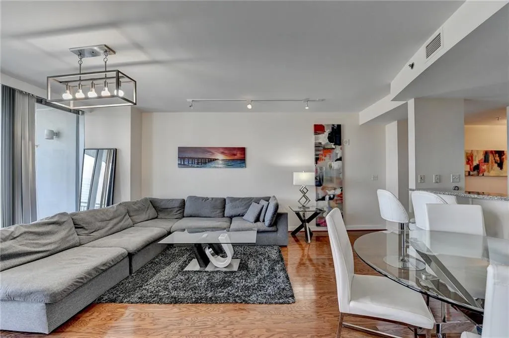 Living room featuring light hardwood / wood-style flooring and rail lighting