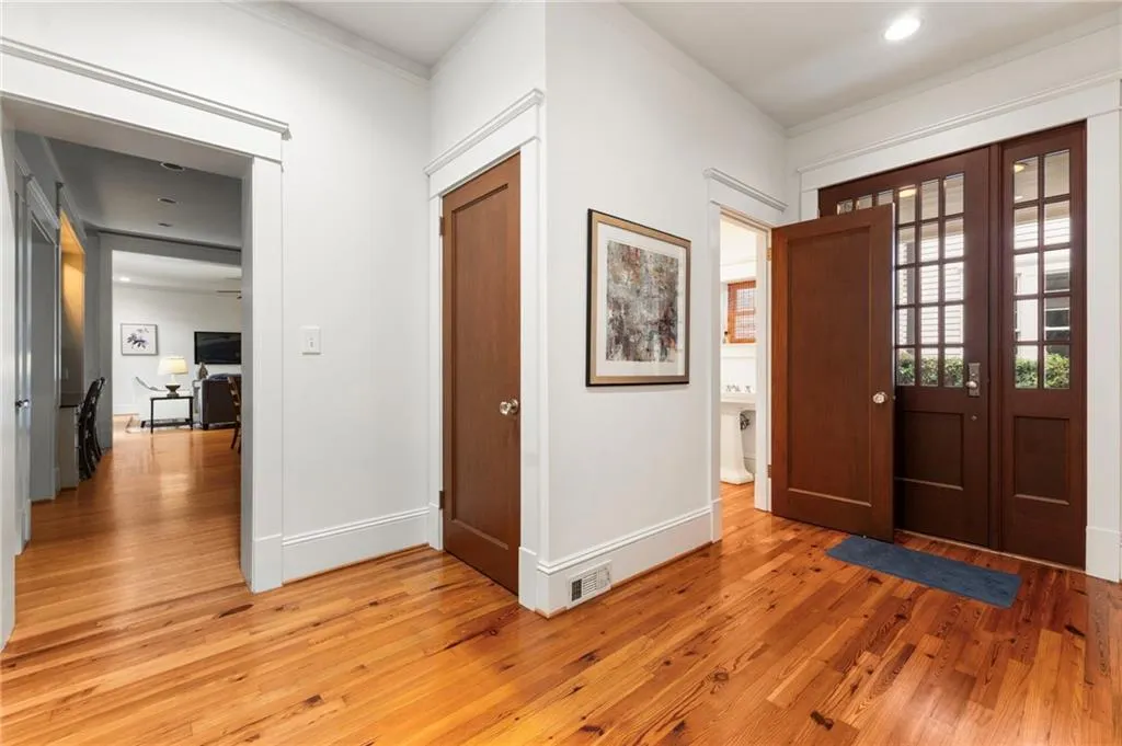 Entryway with light wood finished floors and recessed lighting