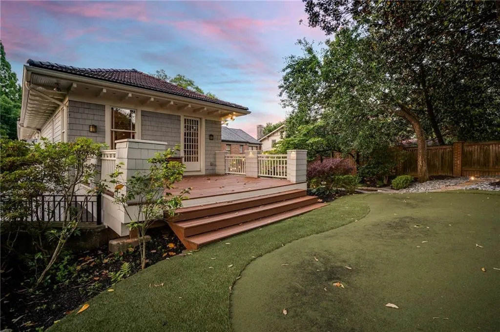 Back of house at dusk with fence and a deck