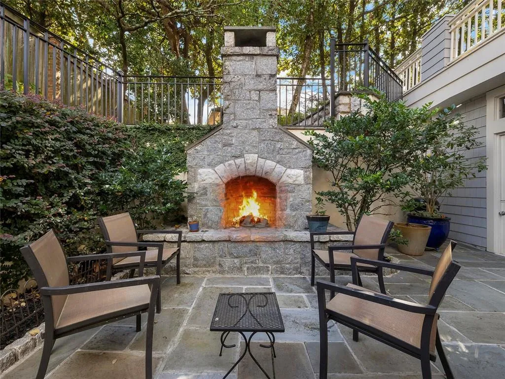 View of patio featuring an outdoor stone fireplace