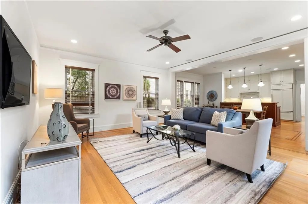 Living area with light wood-style floors, recessed lighting, and a ceiling fan