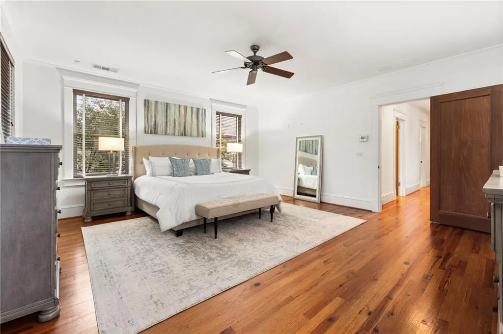 Bedroom with dark wood-type flooring and ceiling fan