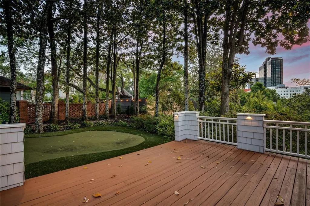 Deck at dusk with a view of city and fence