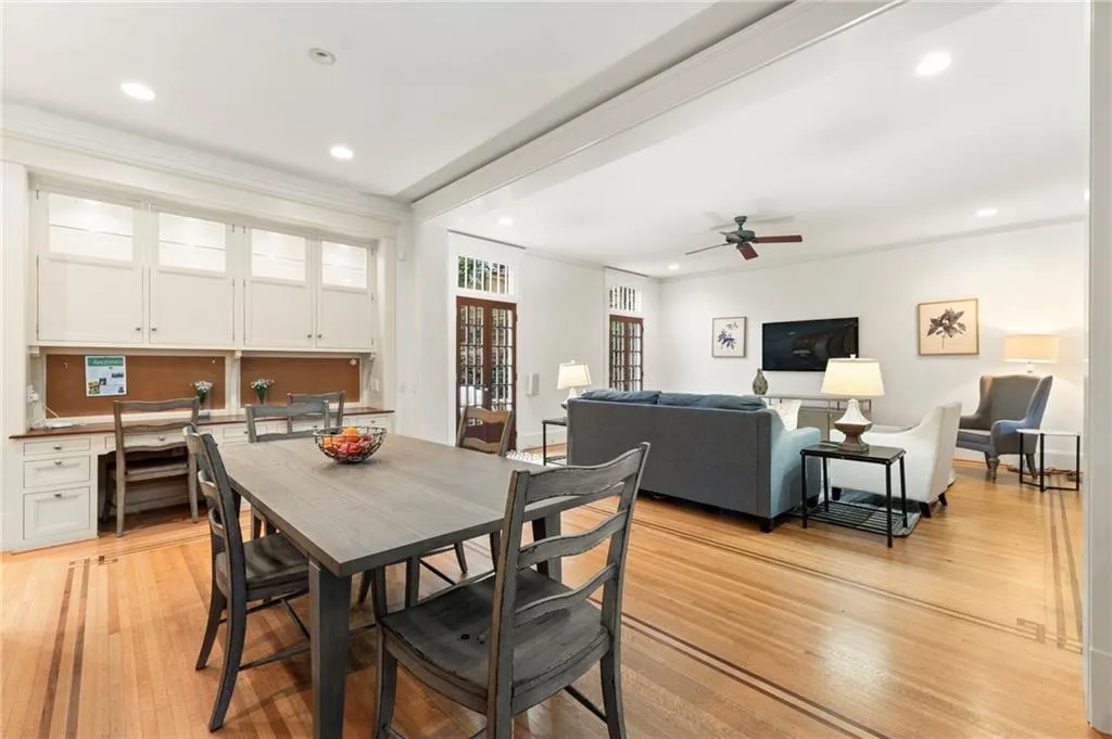 Dining room featuring recessed lighting, light wood-style flooring, built in desk, crown molding, and a ceiling fan