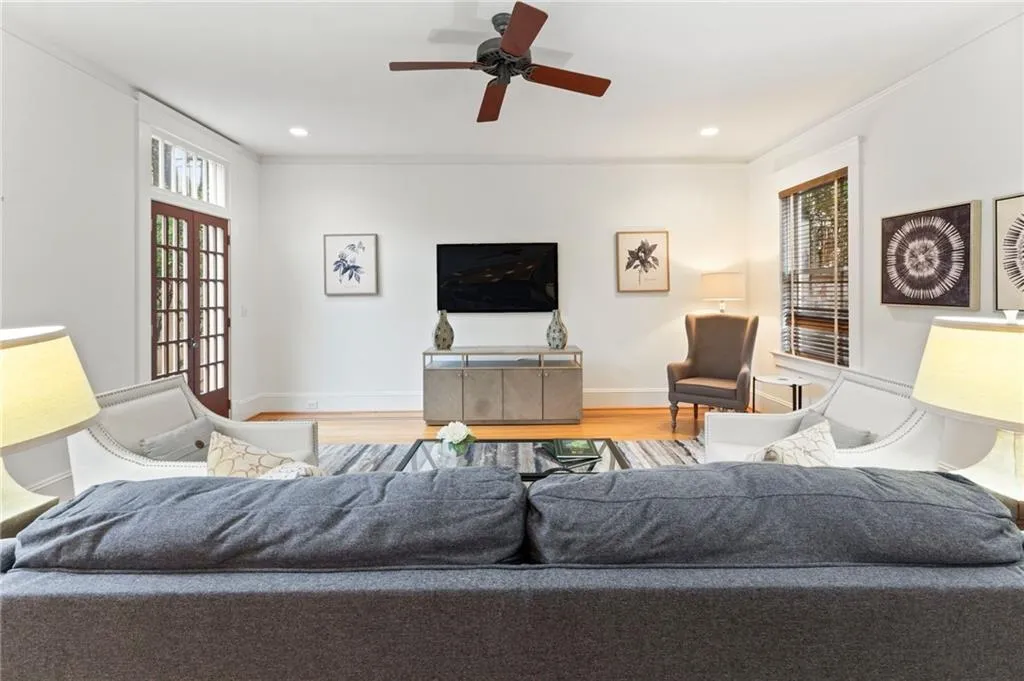 Living area with wood finished floors, ceiling fan, ornamental molding, and recessed lighting