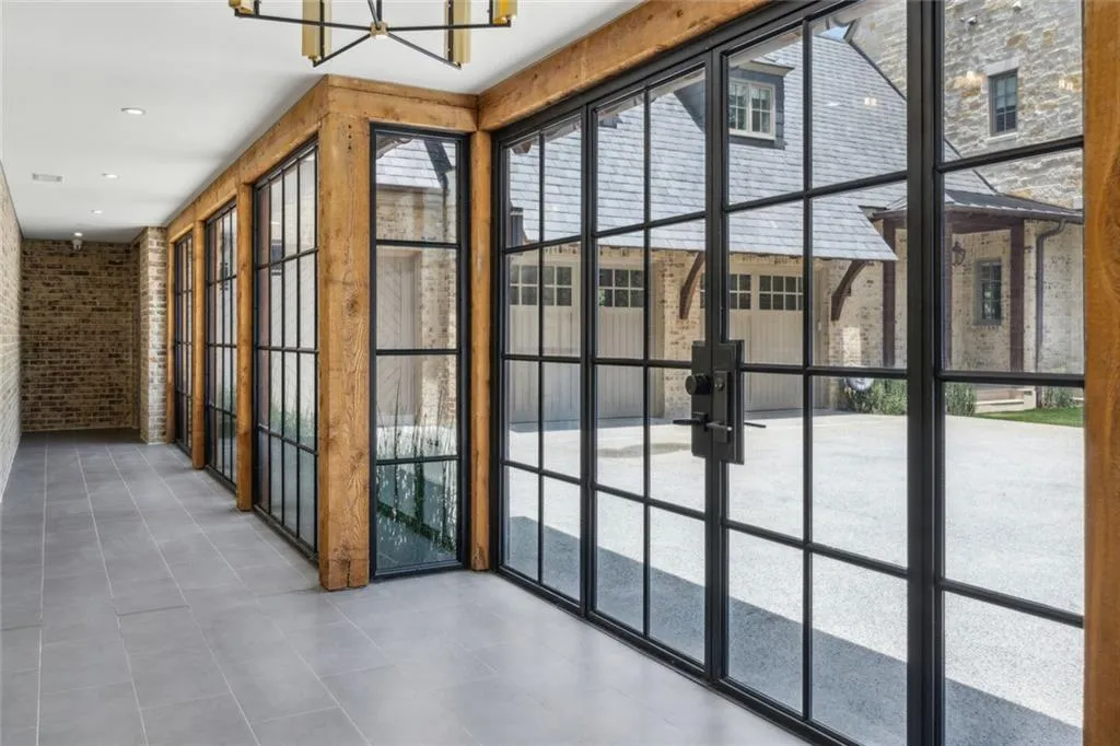 Climate controlled breezeway that connects main house and (2) garages: 3-car and 4-car.