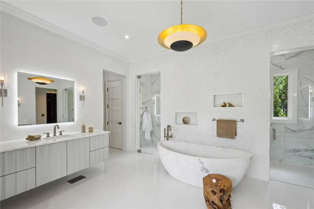 Master bath has separate his/her closest, his/hers water closets, and dual-entry shower room